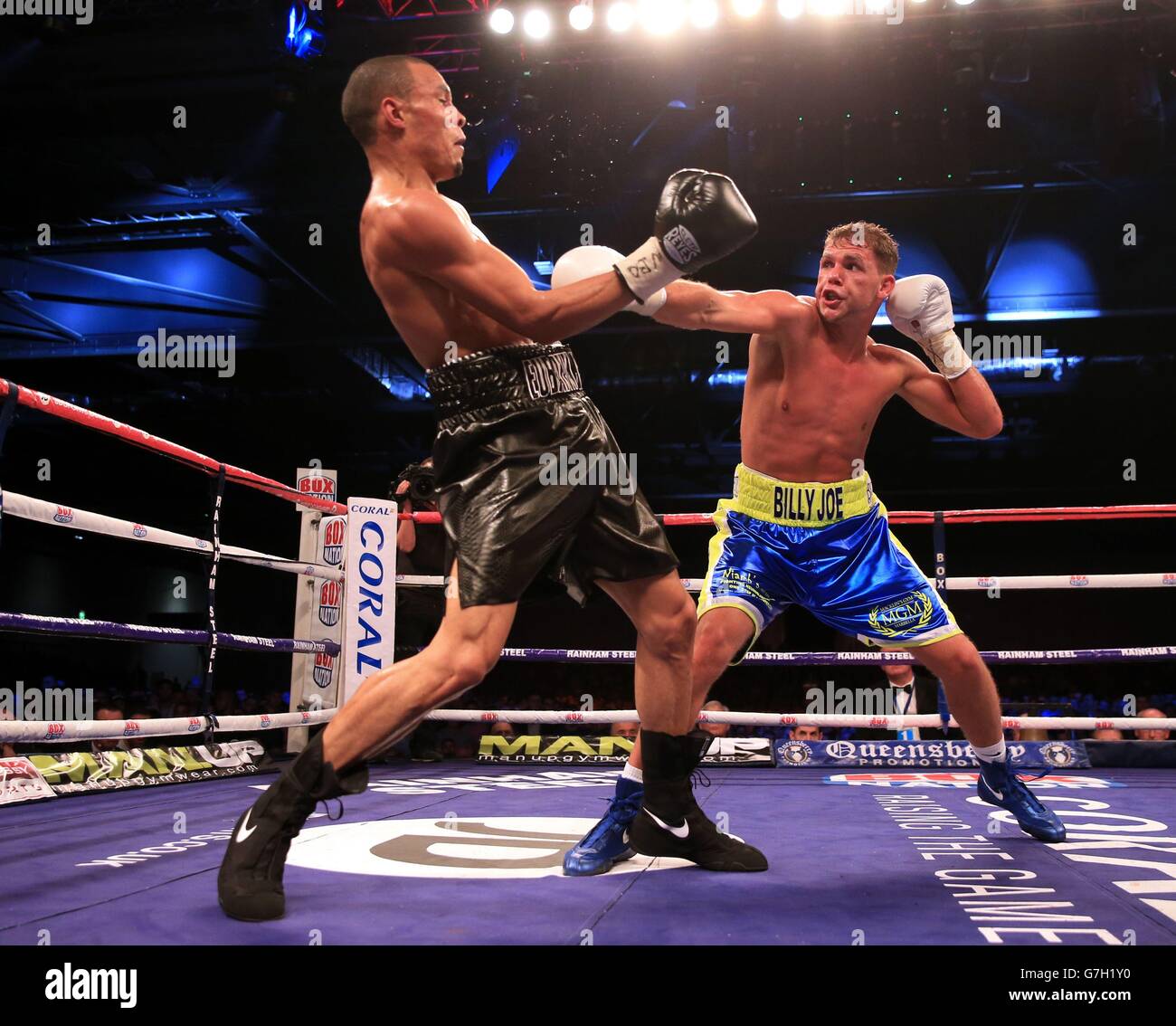 Chris Eubank Junior (left) in action against Bradley Joe Saunders during their British European and Commonwealth middleweight title fight at the ExCel Arena, London. Stock Photo