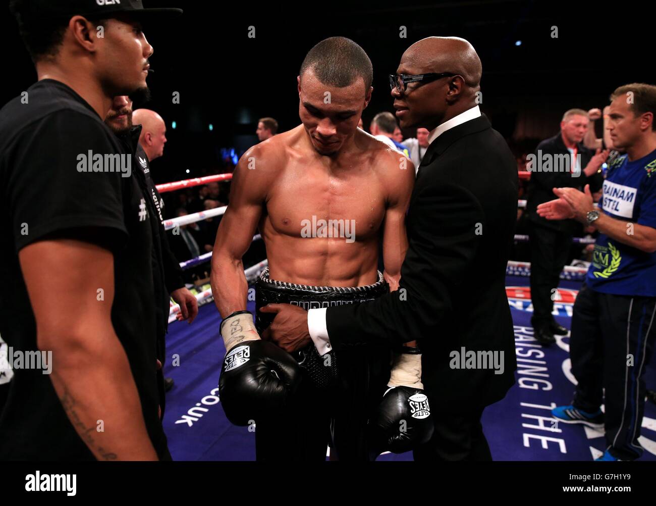 Chris Eubank Junior is consolidated by his father Chris Eubank after losing to Billy Joe Saunders in their British European and Commonwealth middleweight title fight at the ExCel Arena, London. Stock Photo