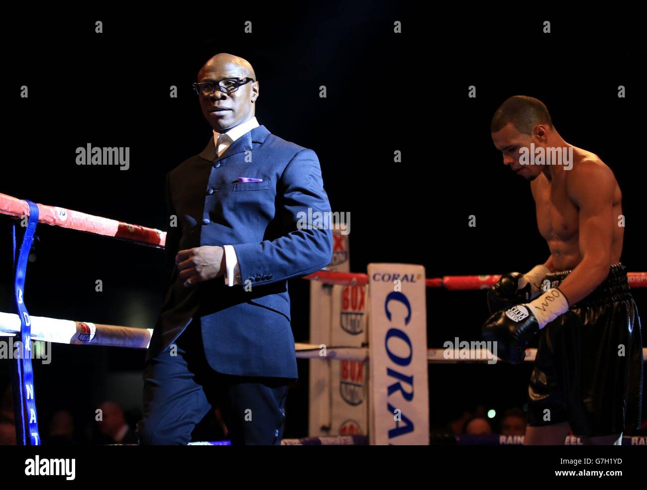 Chris Eubank leads his son, Chris Eubank Junior, out of the ring after he lost to Billy Joe Saunders in their British European and Commonwealth middleweight title fight at the ExCel Arena, London. Stock Photo