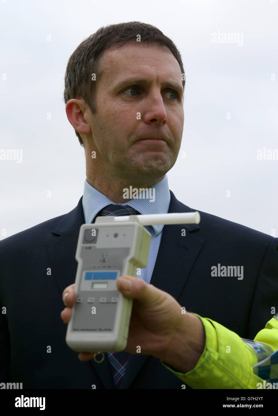 Scottish Justice Secretary Michael Matheson looking at a breathalyser