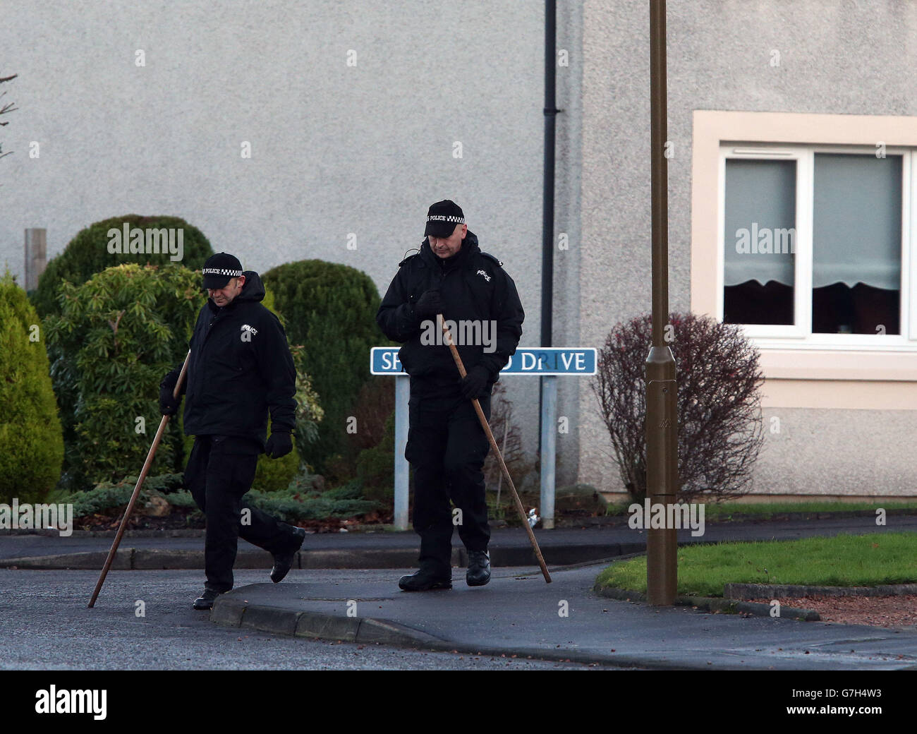 Police search the area in Springfield Drive, Falkirk, as a man is being
