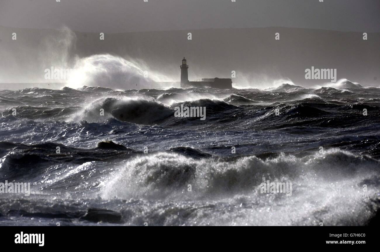 Giant waves hit the lighthouse wall at Whitehaven, as the stormy