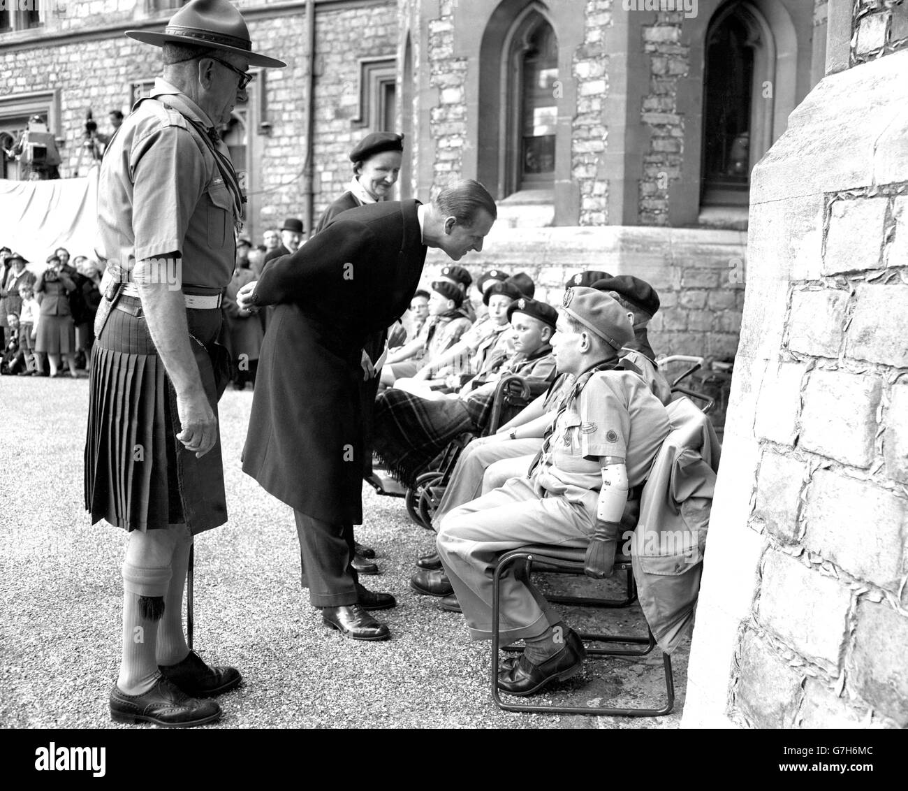 The Duke of Edinburgh stoops to talk to disabled scouts who attended