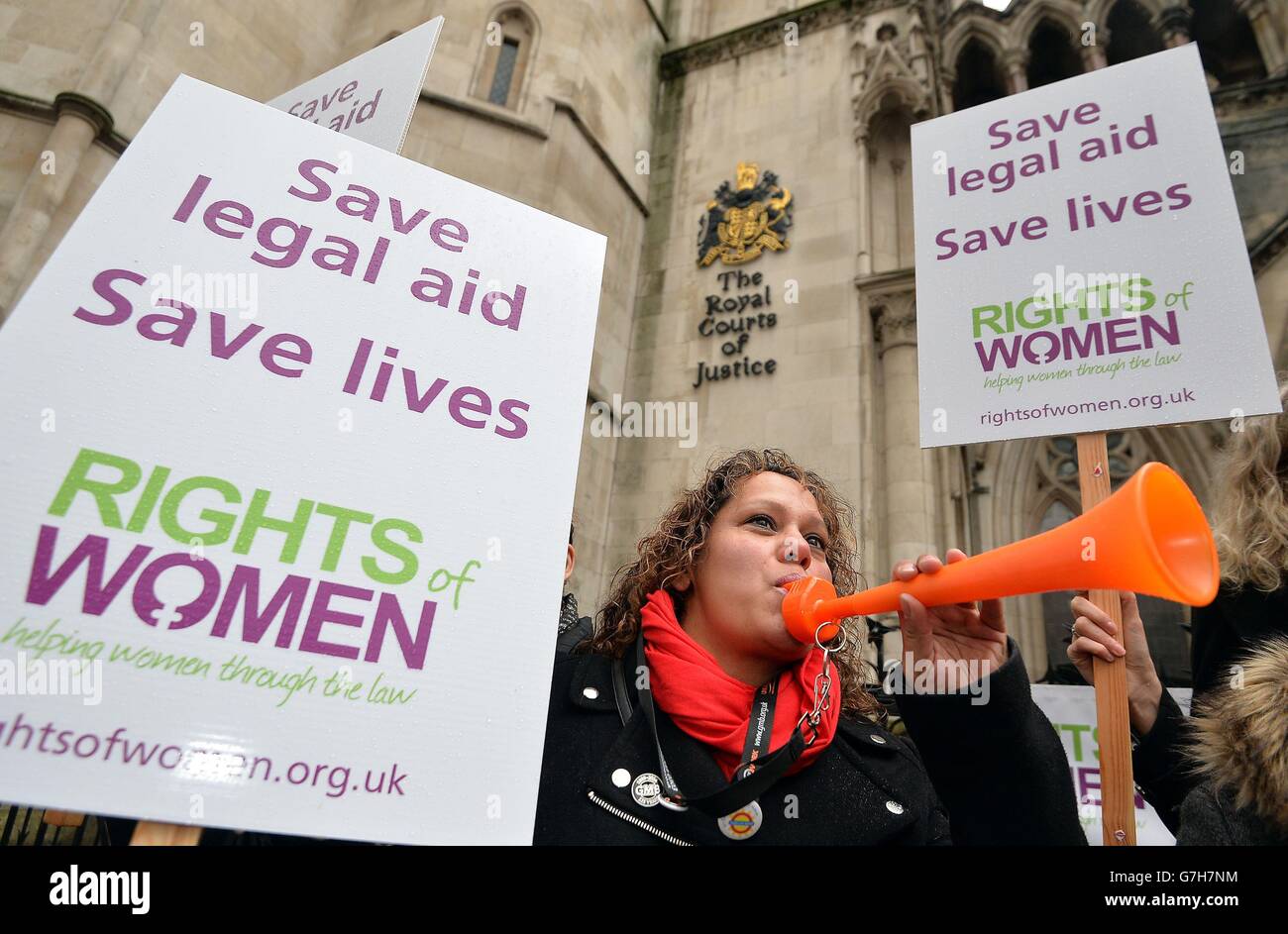Members of Rights Of Women protest outside the High Court, London, as the group mounts a challenge over changes introduced by the Government in April 2013 which require victims to provide a prescribed form of evidence in order to apply for family law legal aid. Stock Photo