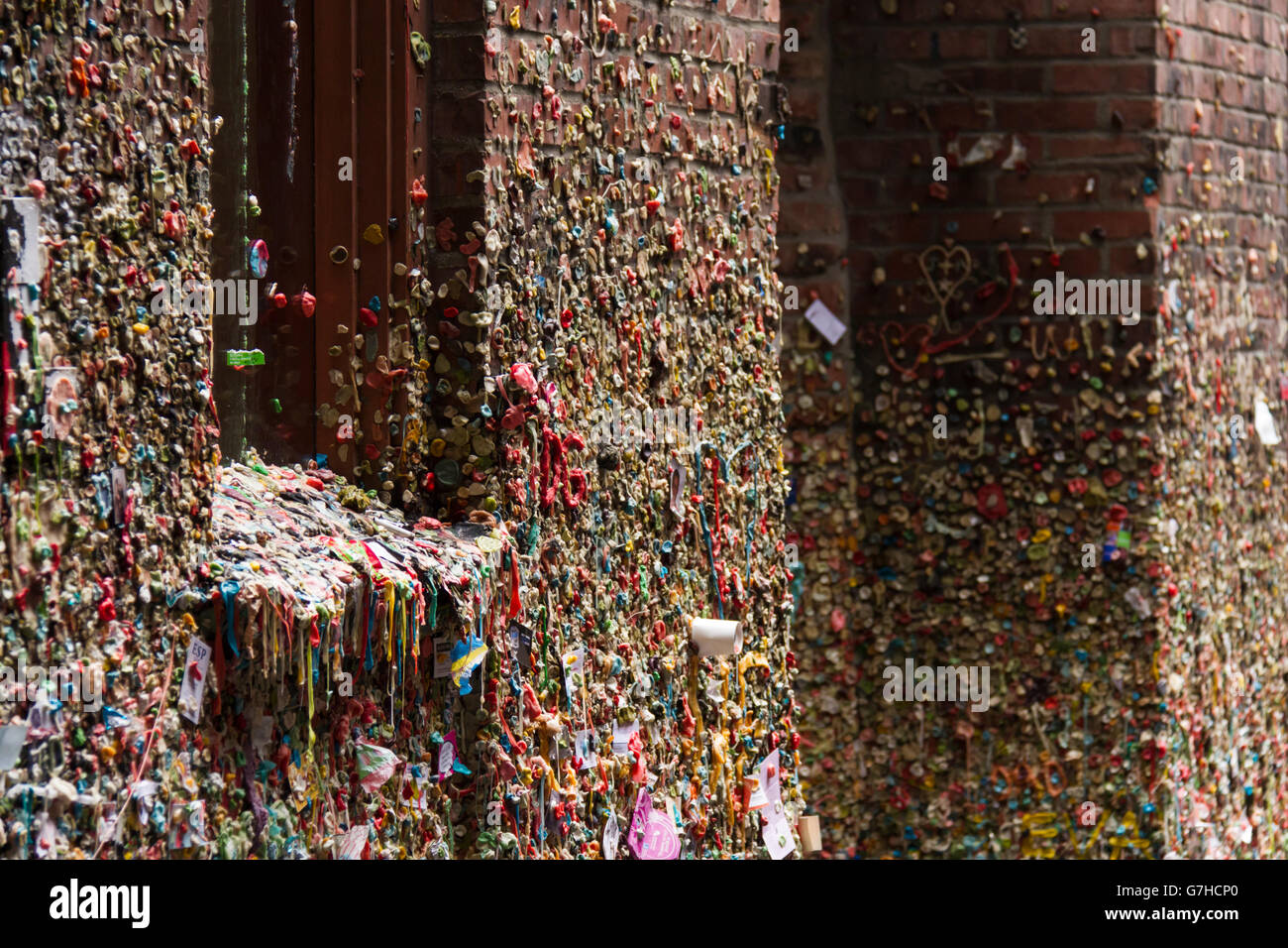 Gum alley (post alley) at the pike place market in Seattle, WA (USA). The walls are covered with multicolored chewing gums. Stock Photo