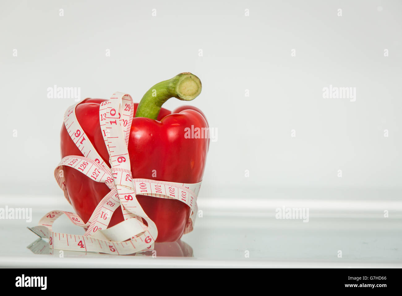 Red sweet pepper with measuring tape. Healthy eating. Healthy lifestyle
