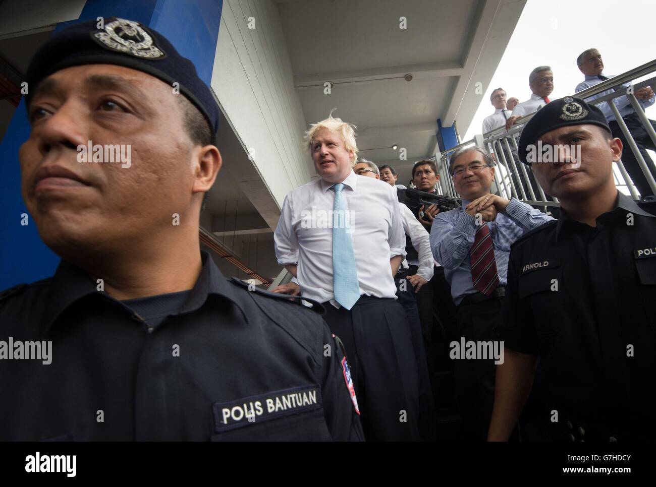 London Mayor Boris Johnson meets local commuters as he travels through Kuala Lumpur, Malaysia, with city mayor Ahmad Phesal Talib (not pictured) after they held meeting at city hall in the Malaysian capital. Stock Photo