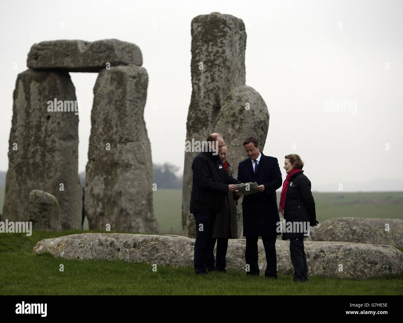 Prime Minister David Cameron (centre) talks with (left to right) Andrew Page-Dove, regional director for the Highways Agency, Simon Thurley, Director for English Heritage and Dame Helen Ghosh, Director General of the National Trust, during a visit to Stonehenge in Wiltshire, as the Government announced today a &pound;15bm investment into Britian's roads. Stock Photo