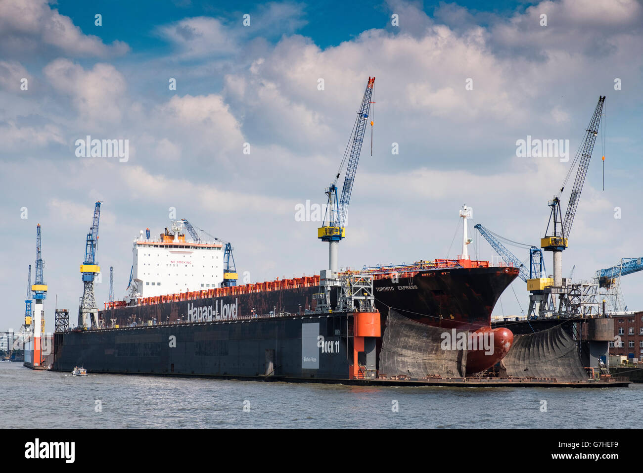 Container ship undergoing repairs in dry dock at  Port of Hamburg on River Elbe in Germany Stock Photo