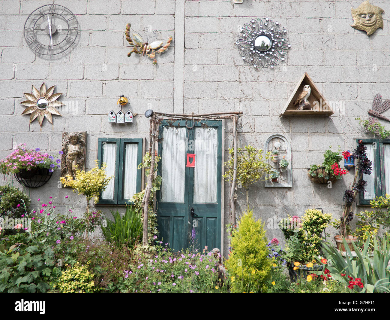 A bland breeze-brick wall that has been decorated to make it more attractive. Stock Photo