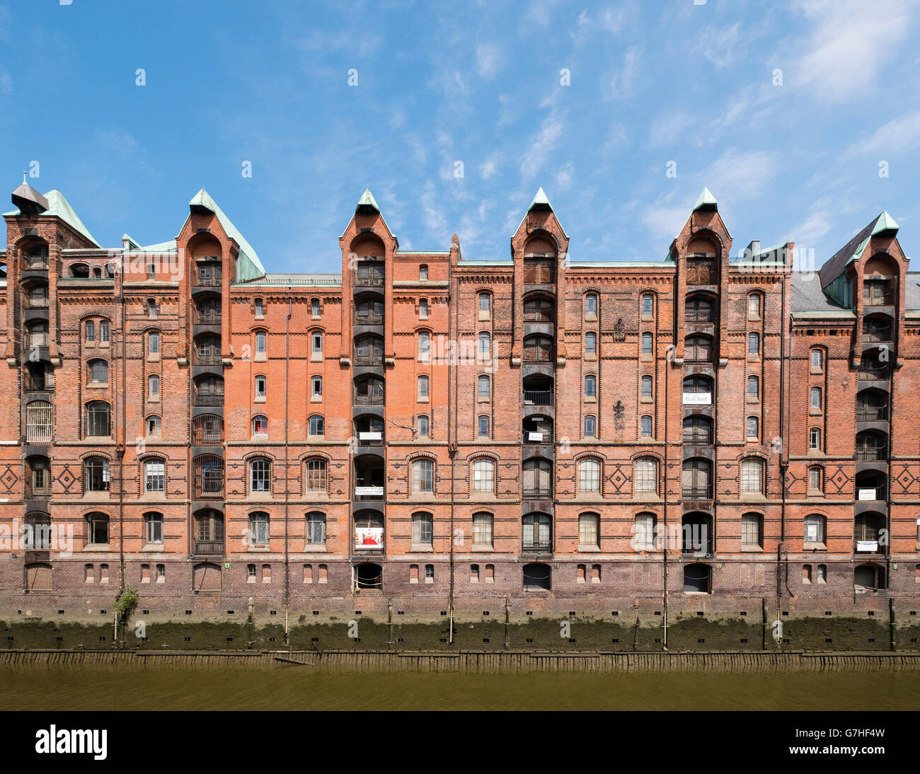 View of historic red brick warehouses at Speicherstadt beside canals in Hamburg Germany Stock Photo