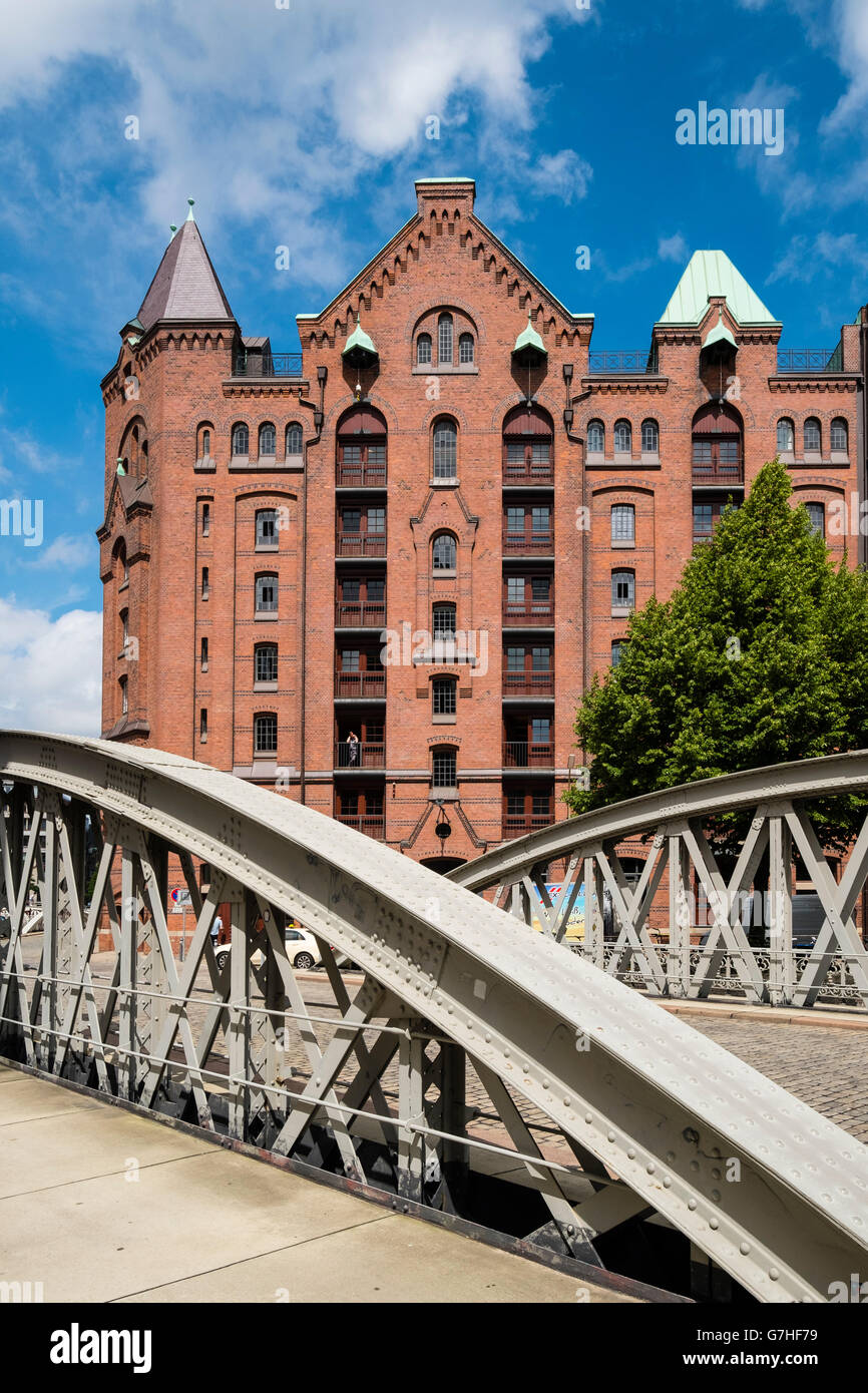View of historic red brick warehouses and bridge at Speicherstadt beside canals in Hamburg Germany Stock Photo