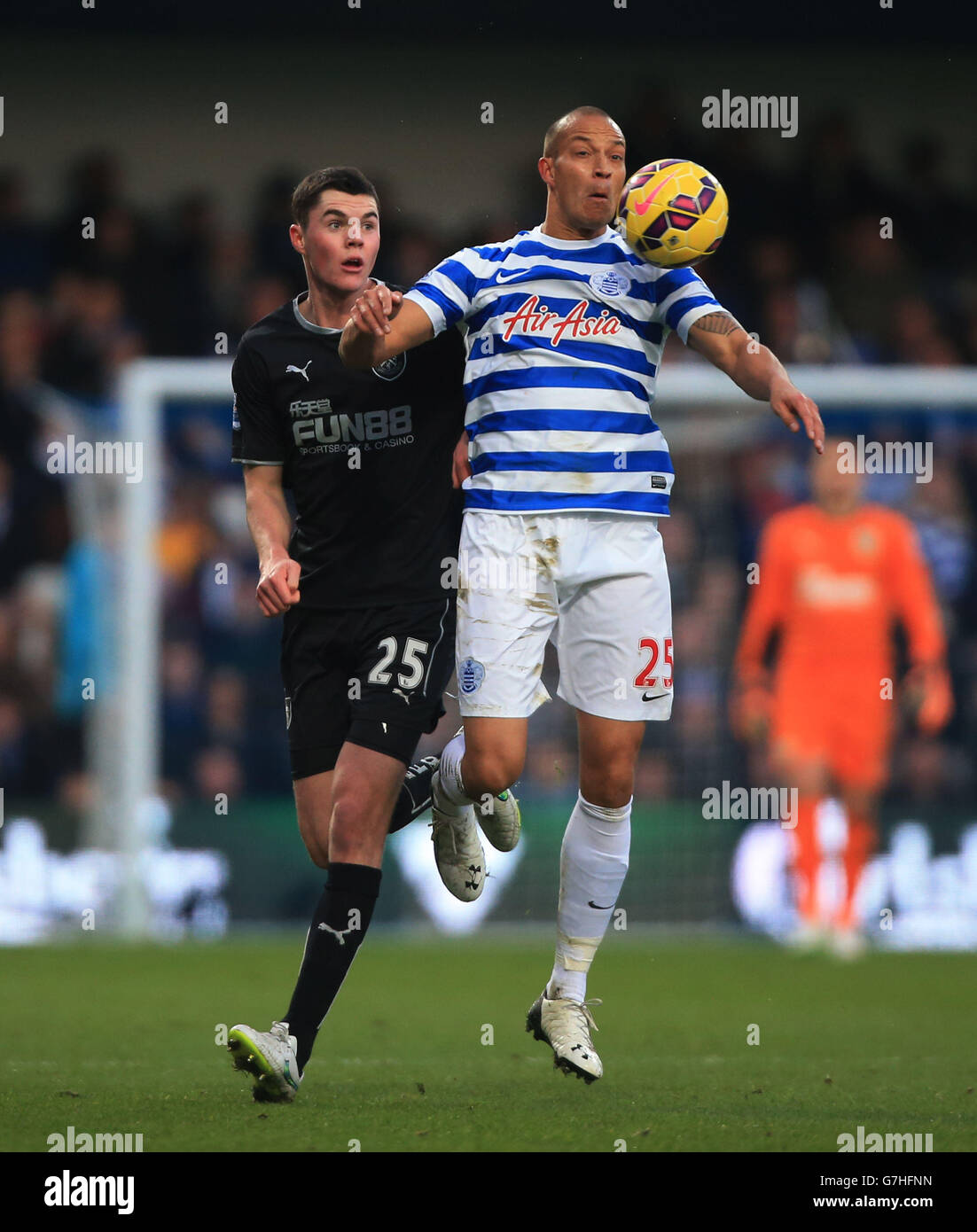 Queens Park Rangers' Bobby Zamora holds off challenge from Burnley's Michael Keane, during the Barclays Premier League match at Loftus Road, London. Stock Photo