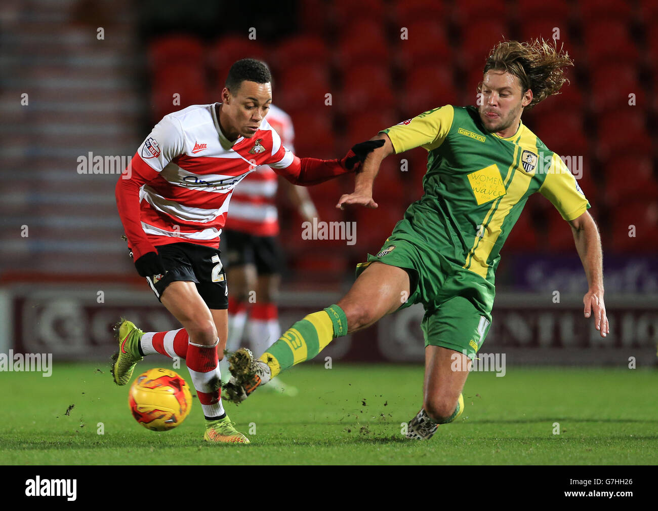 Doncaster Rover's Kyle Bennett (left) and Notts County's Alan Smith battle for the ball. Stock Photo