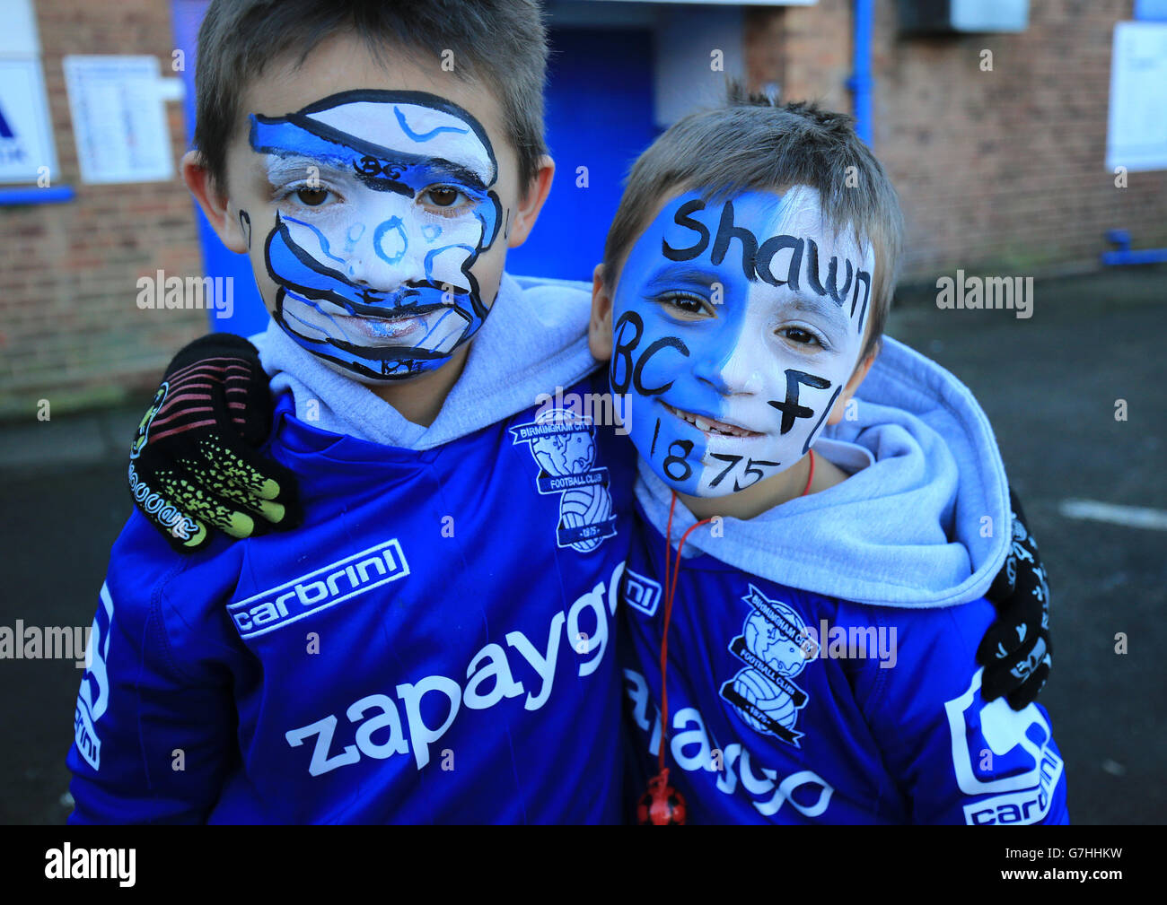 Birmingham City supporters Liam and Shawn Price after having their faces painted before the game against Reading. Stock Photo
