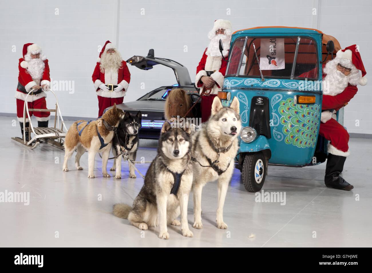 A Delorean, Shetland Pony, Tuk Tuk and Husky Sled part of a special Christmas fleet, prepares to make Shutl deliveries, at a depot in St Albans, Hertfordshire. Stock Photo