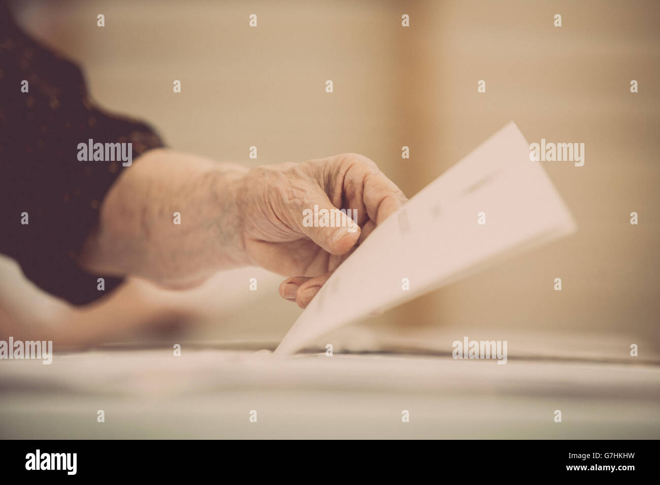 Hand of a person casting a ballot at a polling station during voting. Stock Photo
