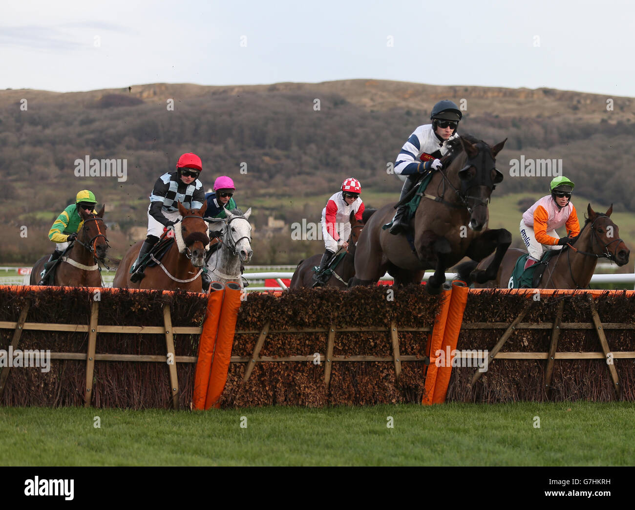 Runners and riders jump a fence in the CF Roberts Electrical + Mechanical Services Handicap Hurdle Stock Photo