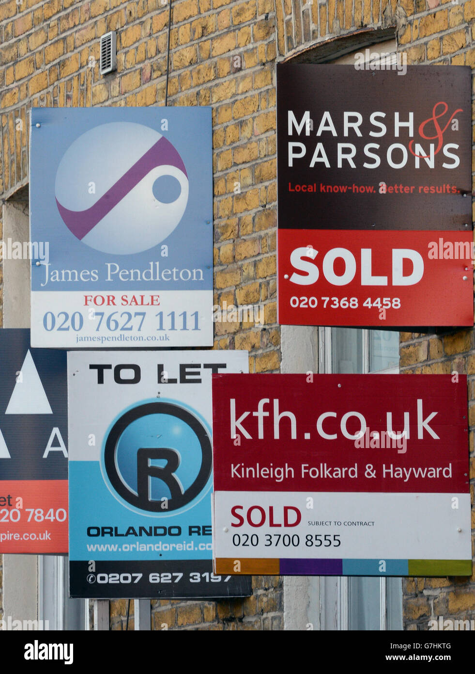 House prices. Estate agent's boards are seen in Clapham, London Stock