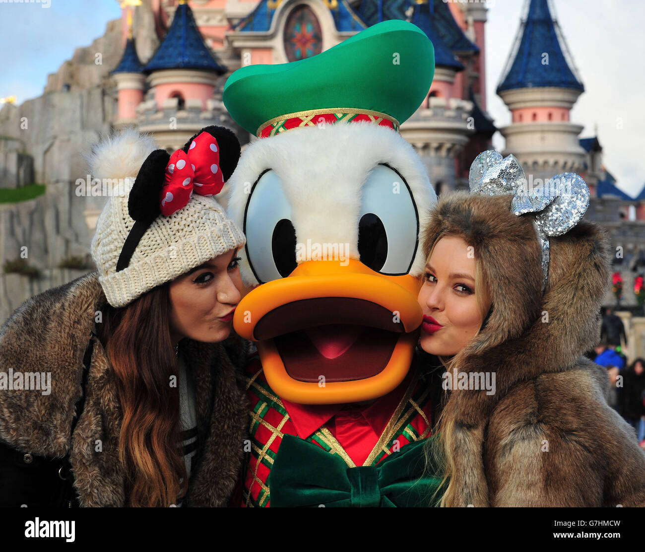 Parisa Tarjomani (left) and Betsey-Blue English of Only the Young, with Donald Duck during the charity trip to Disneyland Paris for under privileged children. PRESS ASSOCIATION Photo. Picture date: Tuesday December 16, 2014. Photo credit should read: Nick Ansell/PA Wire Stock Photo