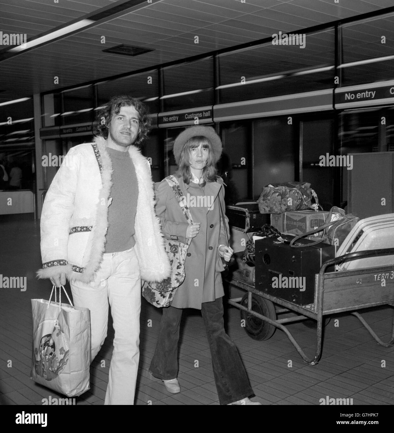 British pop singer Joe Cocker, who was ordered out of Australia after being convicted of possessing drugs, with his girlfriend Eileen Webster, of Sheffield, after they had flown into Heathrow Airport. Stock Photo