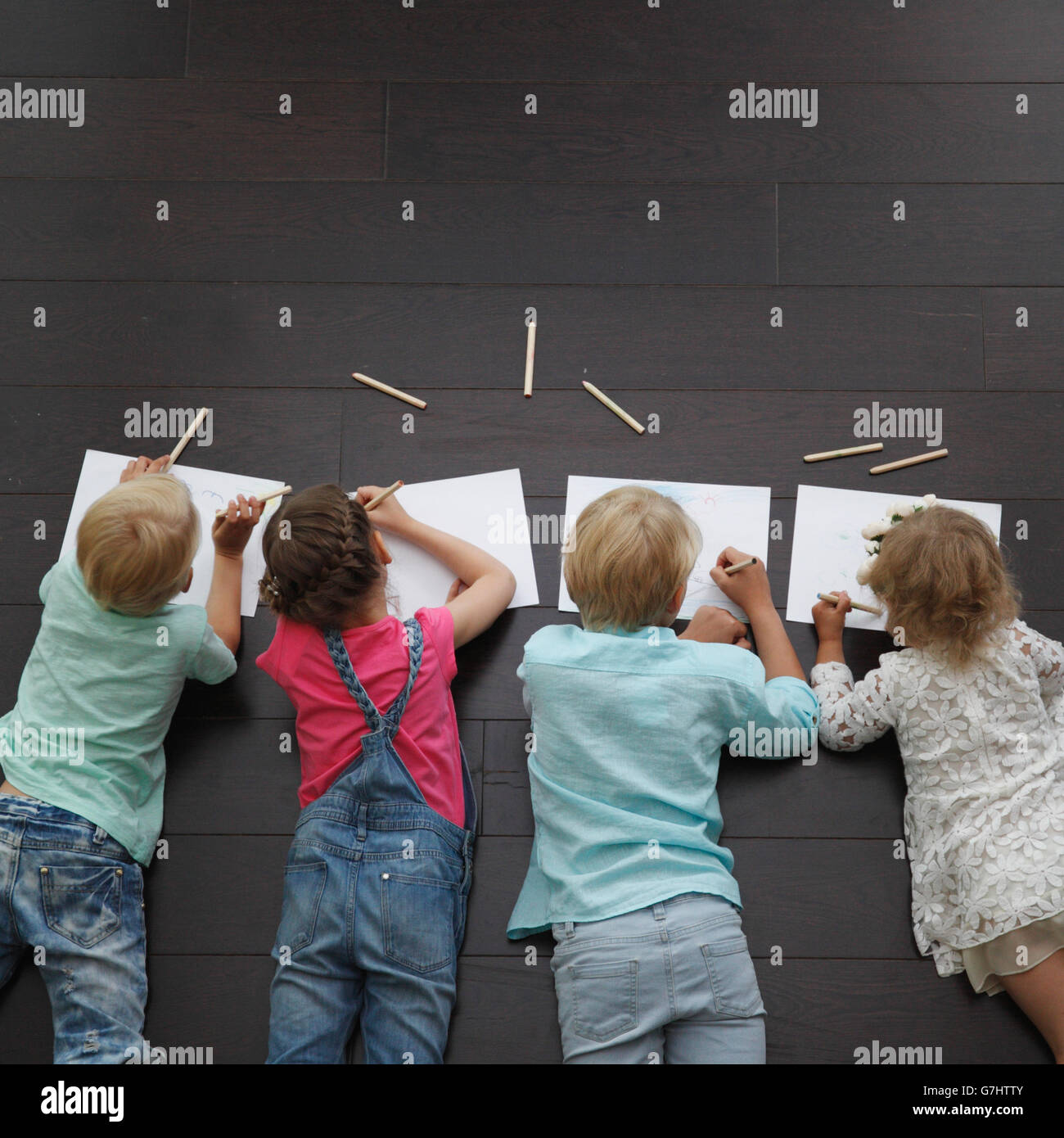 Group of cute children drawing with colorful pencils on floor Stock ...