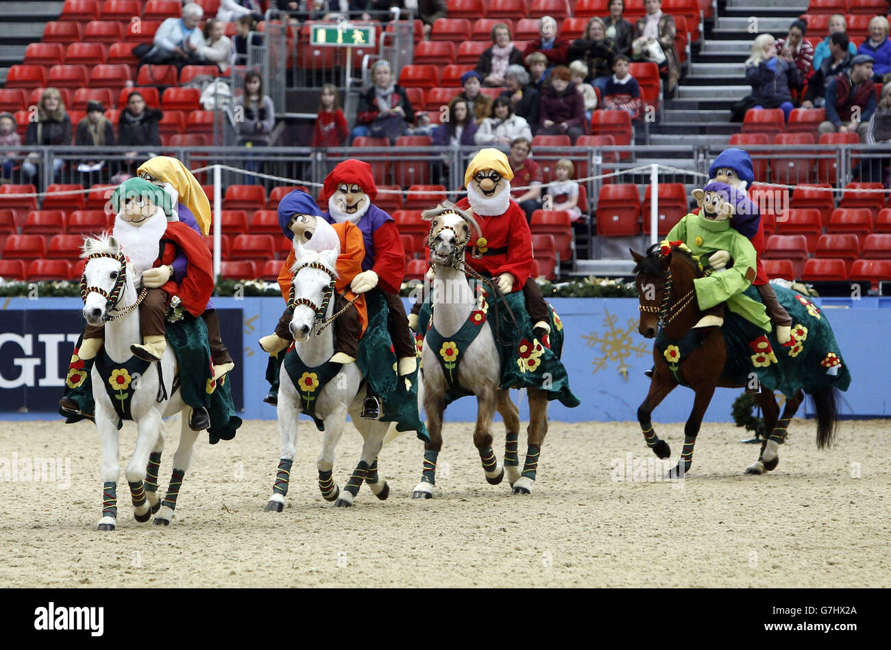 Members of the Saffron Walden & District Riding Club dress as the seven dwarves as they compete in the SEIB/British Riding Clubs Quadrille of the Year during day six of the Olympia London International Horse Show at the Olympia Exhibition Centre, London. Stock Photo