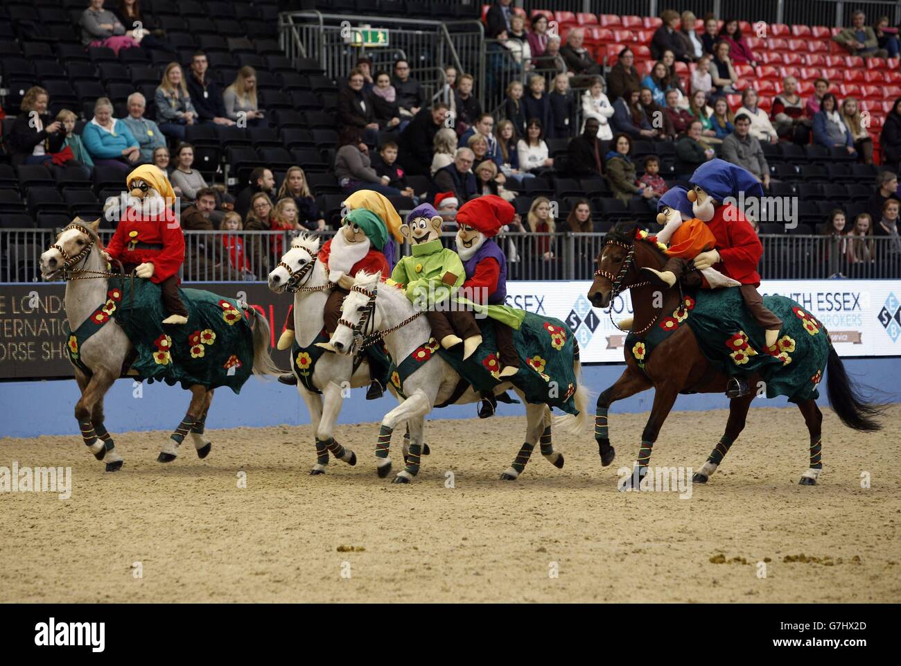 Members of the Saffron Walden &amp; District Riding Club dress as the seven dwarves as they compete in the SEIB/British Riding Clubs Quadrille of the Year during day six of the Olympia London International Horse Show at the Olympia Exhibition Centre, London. Stock Photo