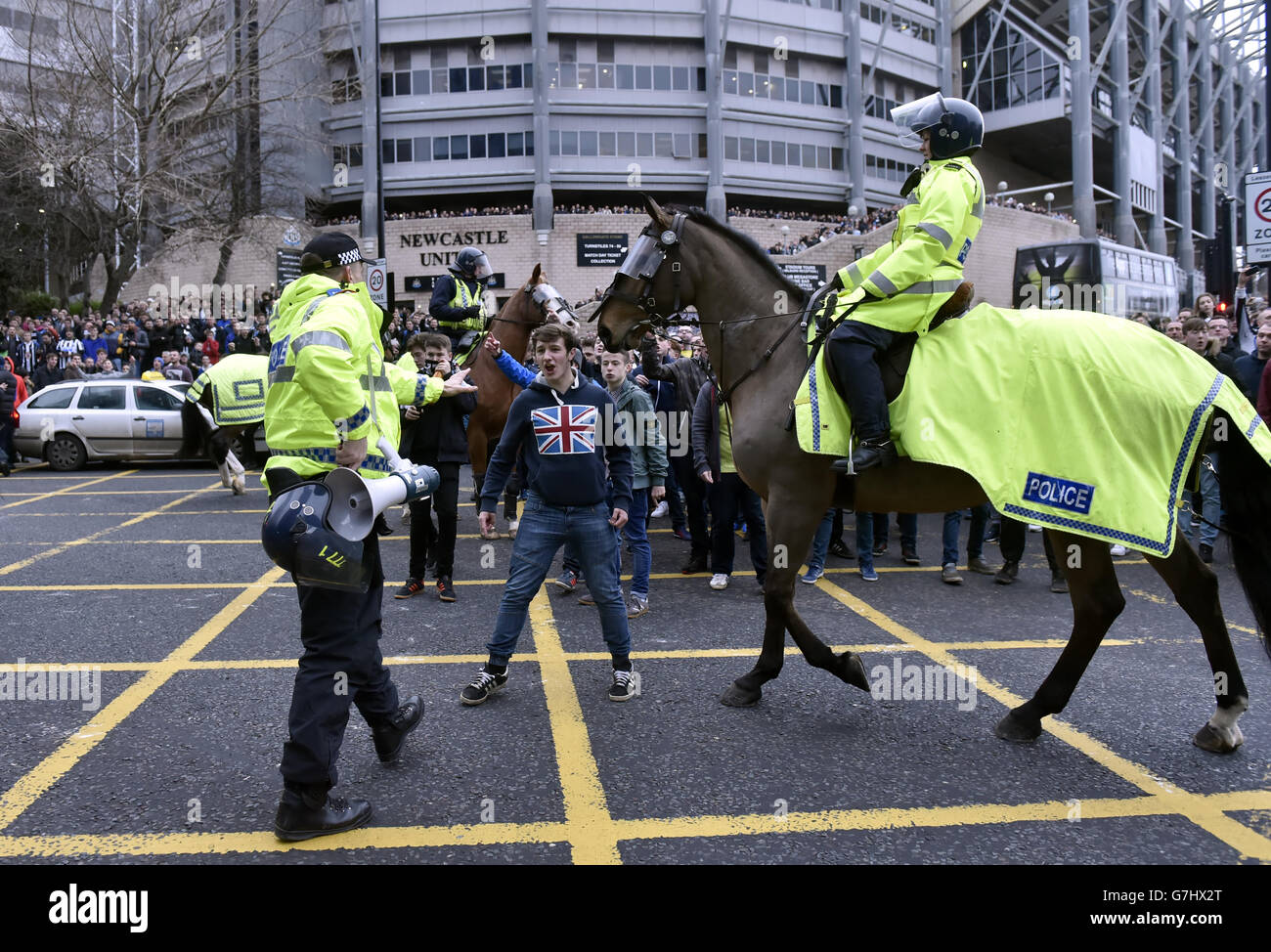 Police and mounted police manage the crowd outside St. James' Park as fans begin to arrive for the Barclays Premier League match at St. James' Park, Newcastle. Stock Photo