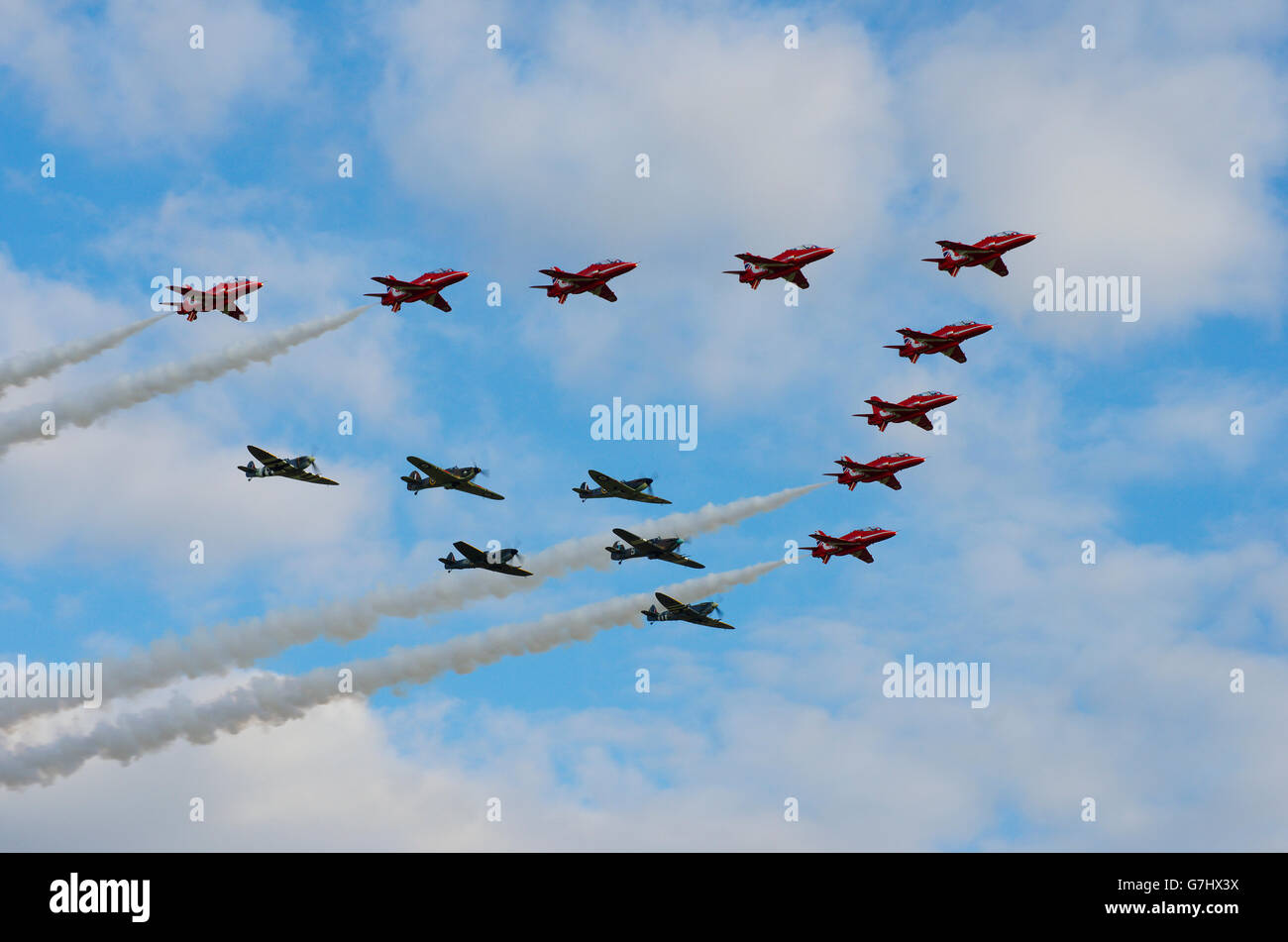 Red Arrows in formation with RAF Battle of Britain Fighters Stock Photo
