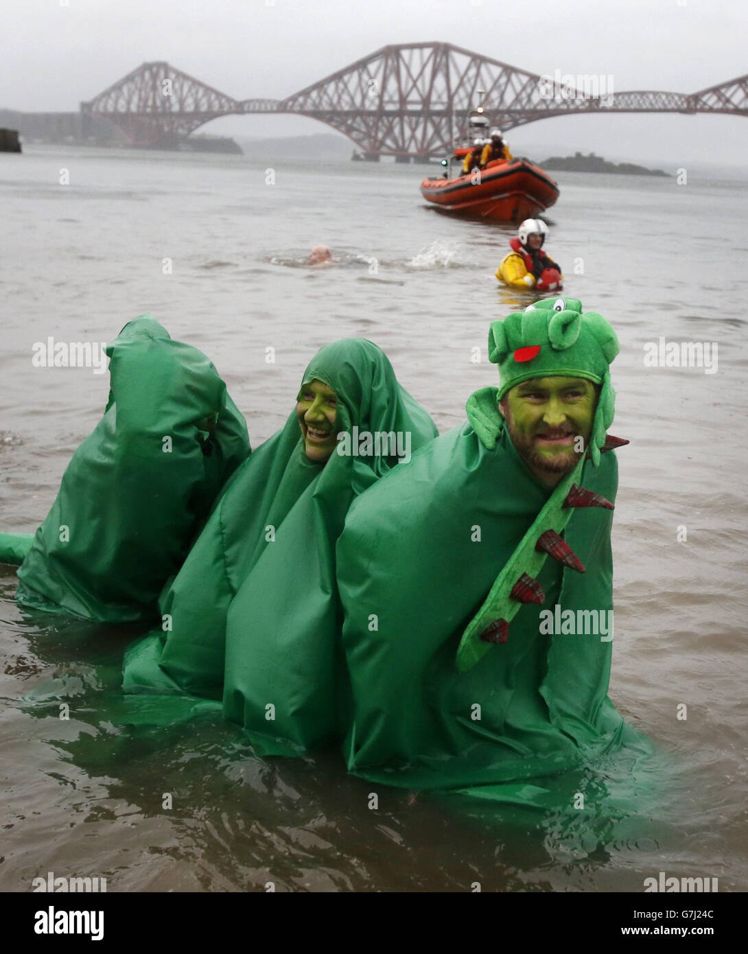 Swimmers take part in the Loony Dook New Year's Day dip in the Firth of ...