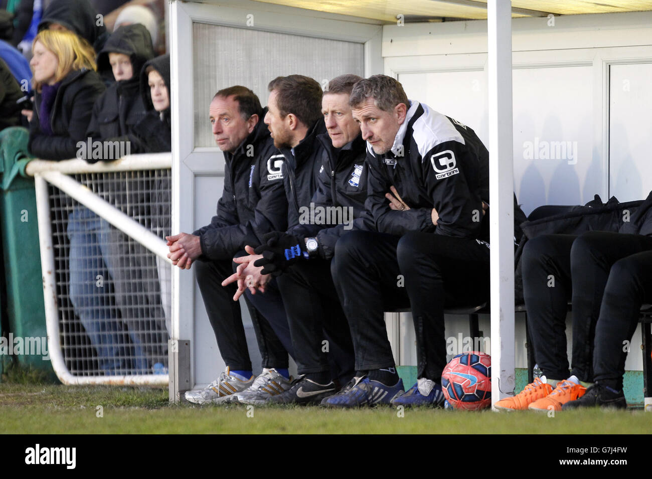 (L-R) Birmingham City's Assistant Manager Kevin Summerfield, Manager Gary Rowett, Goalkeeping coach Kevin Poole and First Team Coach Mark Sale on the bench at Croft Park Stock Photo