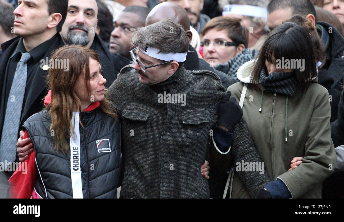 Charlie Hebdo newspaper staff, with cartoonist Renald Luzier, known as Luz, (centre with moustache) lead world leaders at the start of the defiant march through Paris, France, in the wake of the terror attacks. Stock Photo