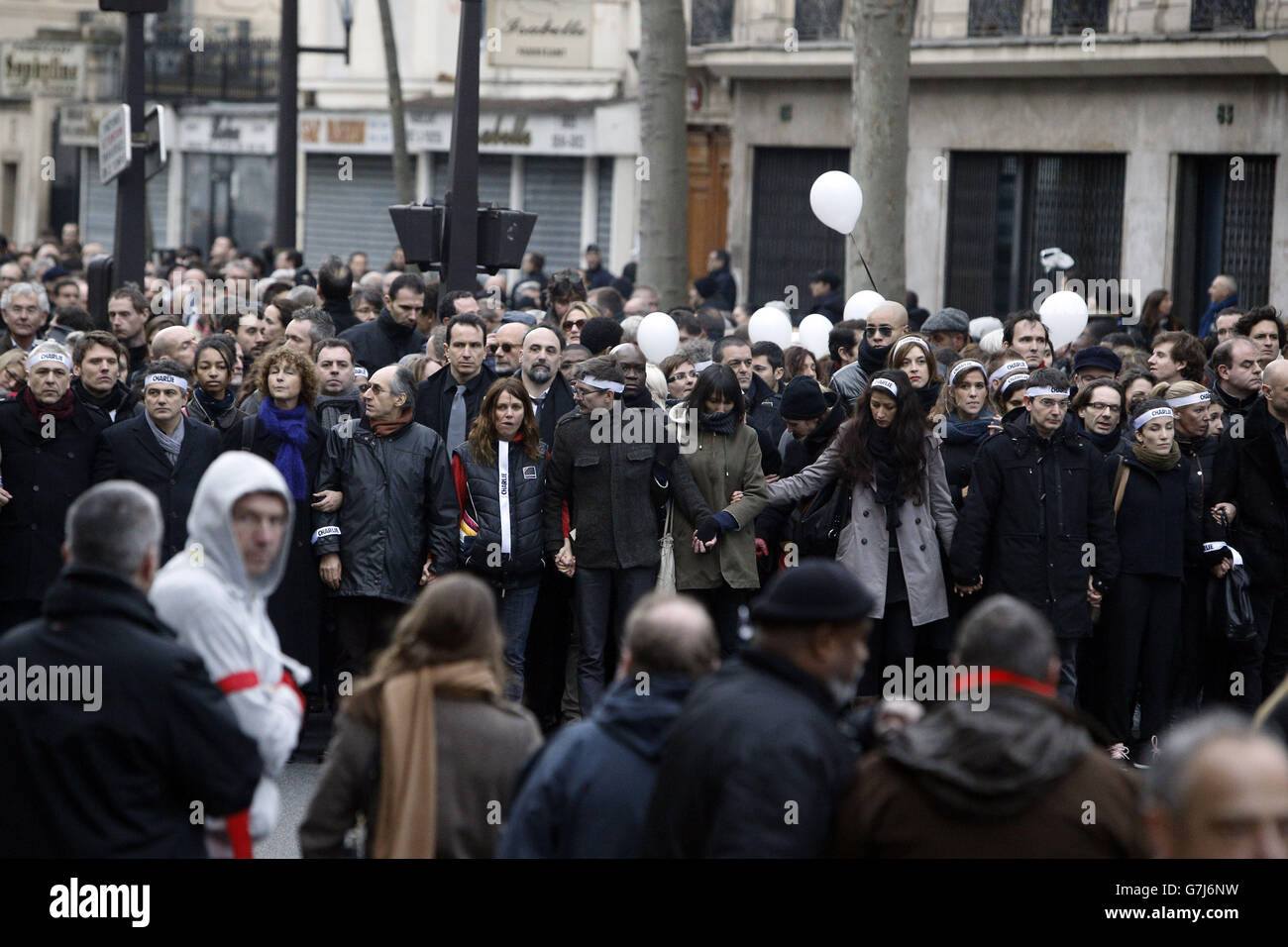 Charlie Hebdo newspaper staff, with cartoonist Renald Luzier, known as Luz, (centre with moustache) lead world leaders at the start of the defiant march through Paris, France, in the wake of the terror attacks. Stock Photo