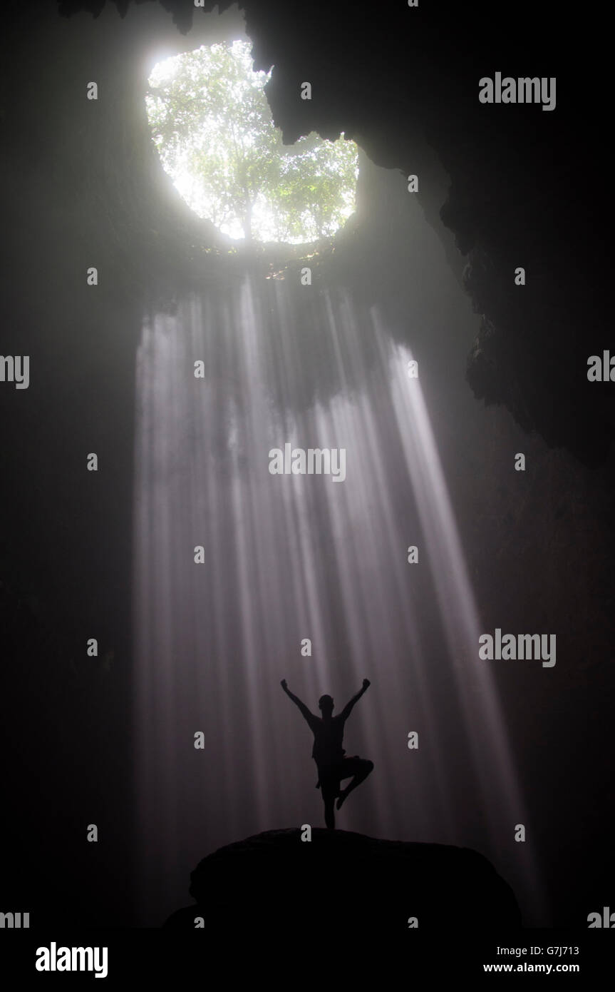 Jomblang Cave - An Ancient Forest and Heavenly Light in The Bowel of The Earth Stock Photo