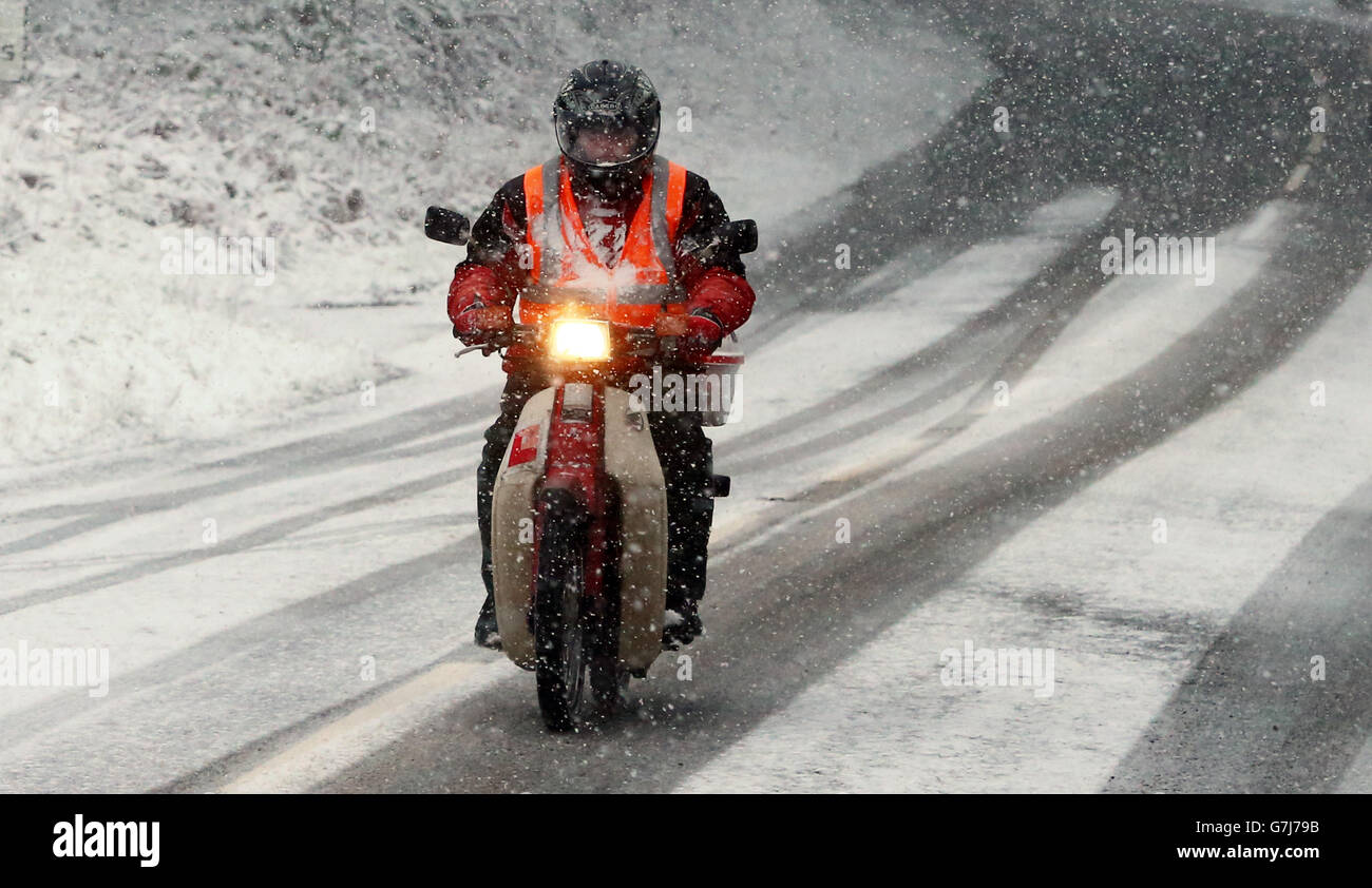 Motorists make their way through snowfall in Gortin near Omagh, as many parts of the UK were on snow alert with wintry showers threatening to disrupt travel. Stock Photo