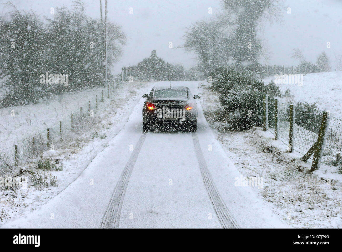 Motorists make their way through snowfall in Gortin near Omagh, as many parts of the UK were on snow alert with wintry showers threatening to disrupt travel. Stock Photo