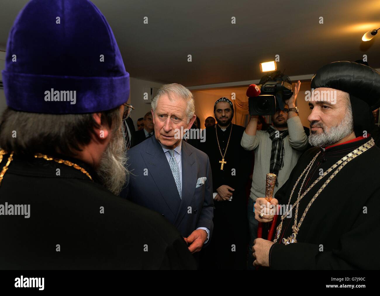 The Prince of Wales (centre left) talks to some of the local Priests, during his visit to St Thomas Cathedral, the Syrian Orthodox Church in Acton west London, where he met members of the congregation from Iraq and Syria who have fled persecution. Stock Photo