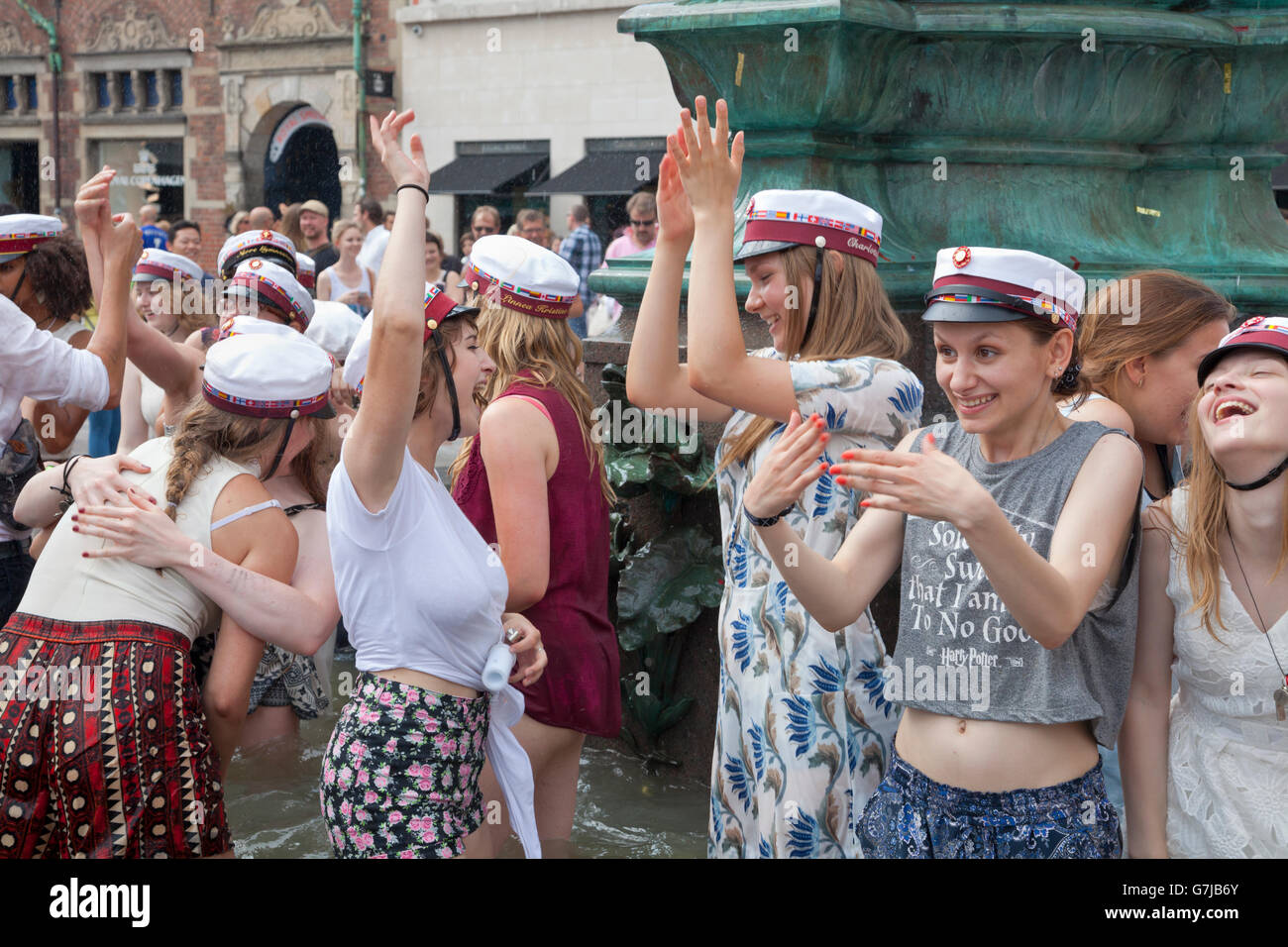 Danish students celebrate their high school, grammar school, graduation with the traditional dip in the Stork Fountain on Stroeget in Copenhagen. Stock Photo