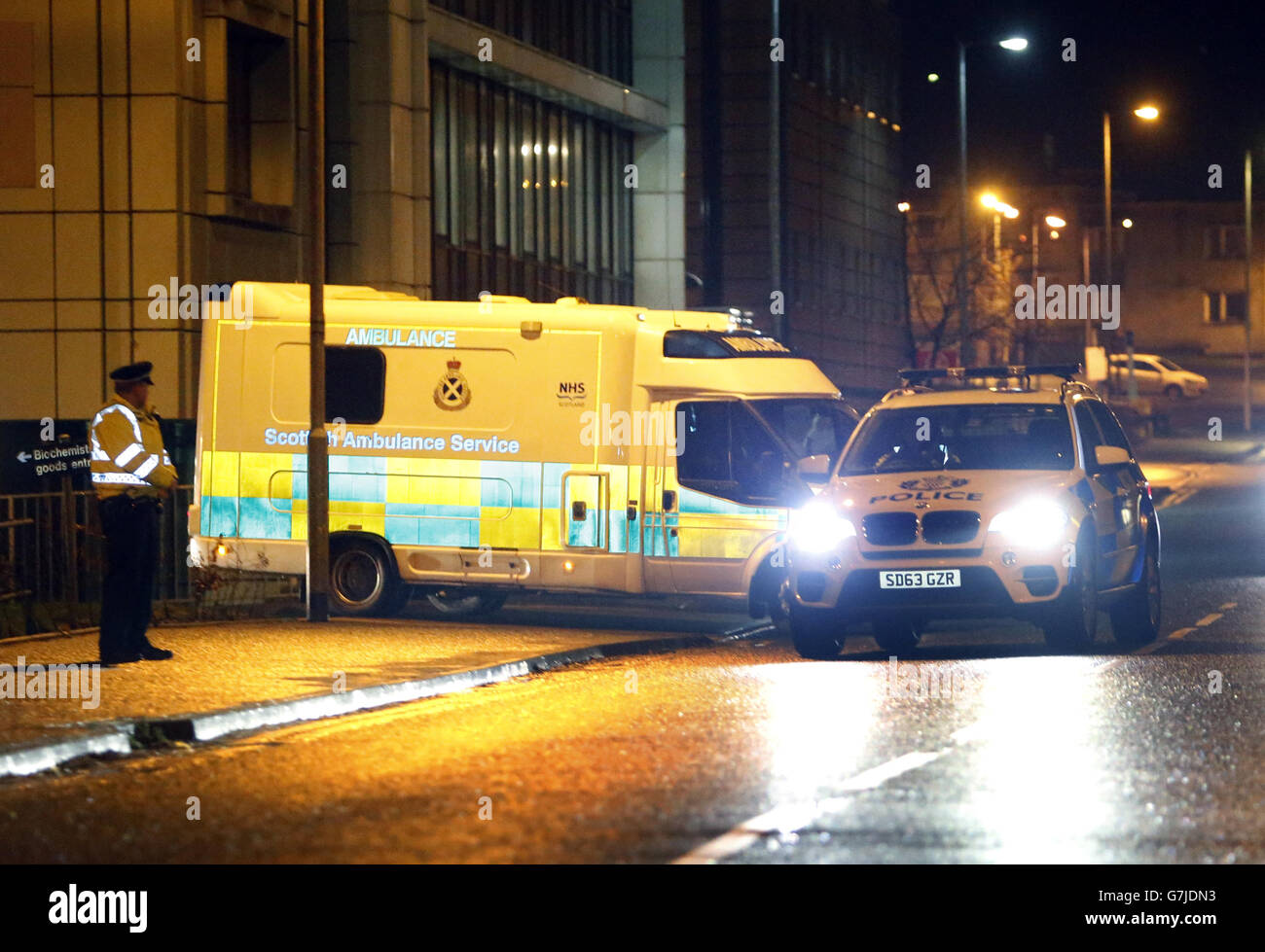 A healthcare worker is moved from the Brownlee Unit for Infectious Diseases at the Gartnavel Hospital campus, Glasgow, to Glasgow Airport ahead of being taken to the Royal Free Hospital in London, after she was diagnosed with Ebola after returning from Sierra Leone. Stock Photo