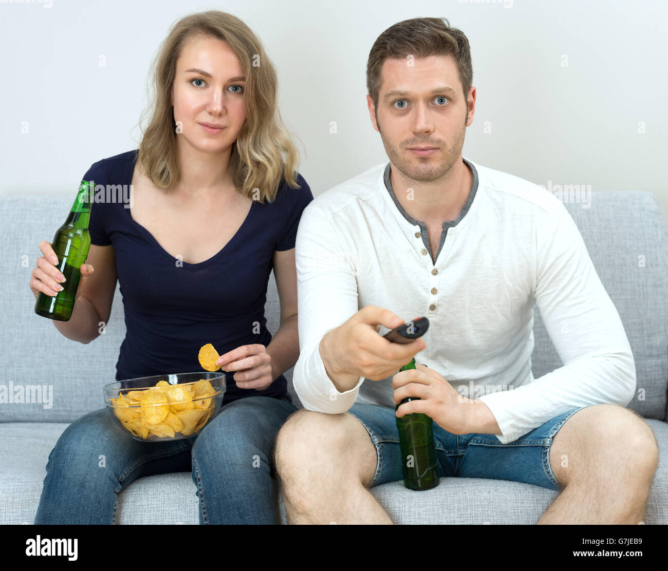 Man and woman watching sports match on tv. Stock Photo