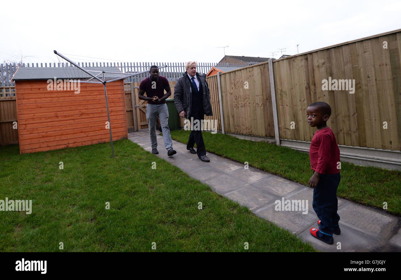 Mayor of London Boris Johnson meets Adkrunle Shina and his children, who live in a house at the new Erith Park housing development in Kent, which is made up of 80% affordable housing designed to help buyers on low to medium incomes. Stock Photo