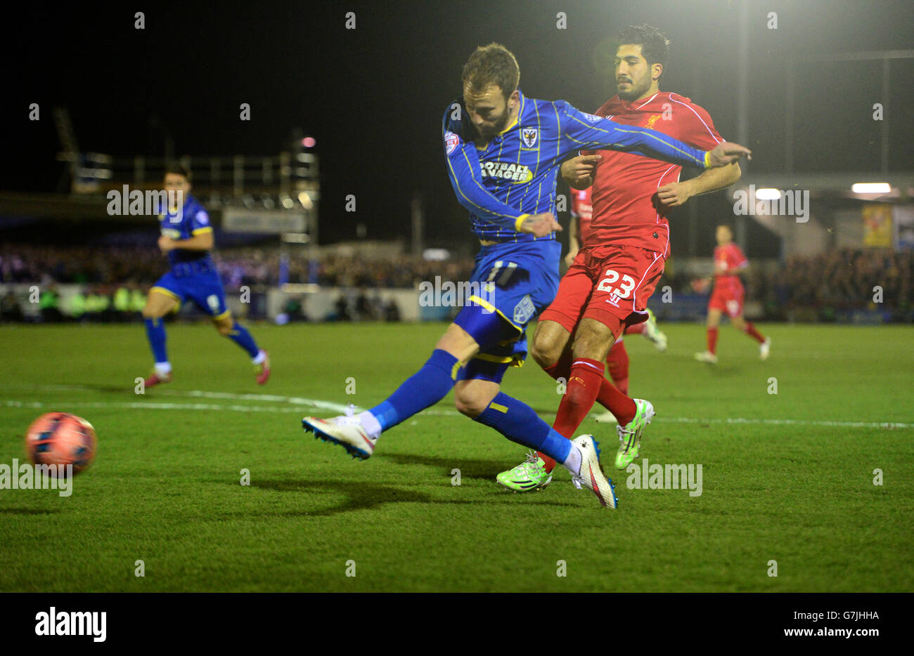 AFC Wimbledon's Sean Rigg and Liverpool's Emre Can battle for the ball during the FA Cup, Third Round match at The Cherry Red Records Stadium, London. Stock Photo
