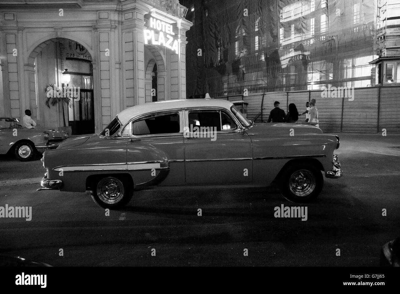 Streets of Old Havana at night with old American car. Black & white image Stock Photo