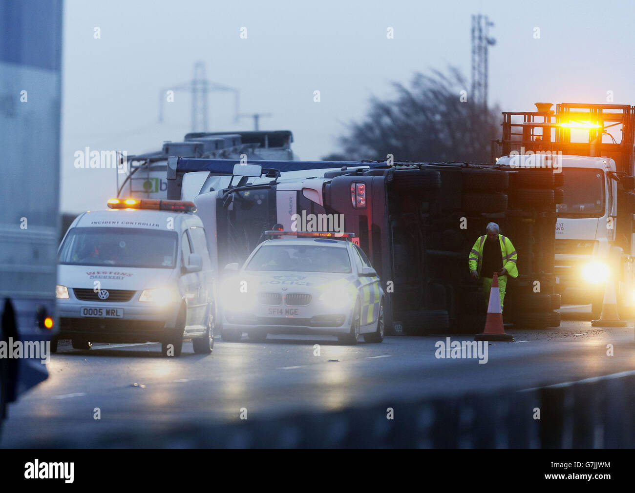 Police at the scene between junction 9 and 10 of the M74 near Kirkmuirhill, South Lanarkshire, after a lorry was blown over in heavy wind. Stock Photo