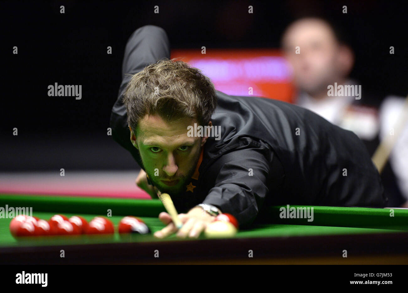 Judd Trump takes a shot right handed during his match against Stephen Maguire on day two of the 2015 Dafabet Masters at Alexandra Palace, London. Stock Photo