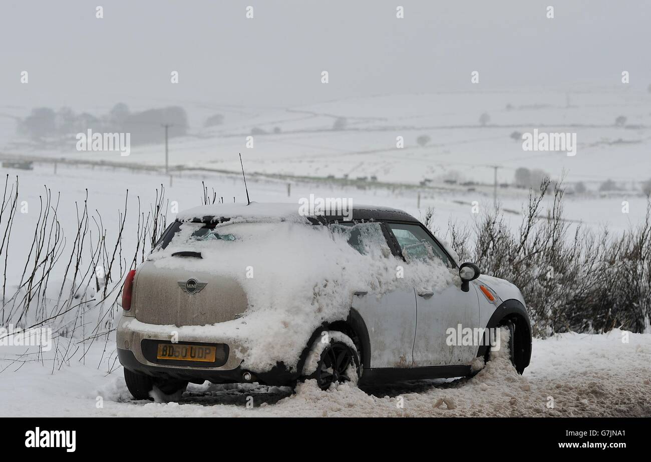 An abandoned car on the side of the A515 between Ashbourne and Buxton in Derbyshire following the coldest night of 2014 . Stock Photo