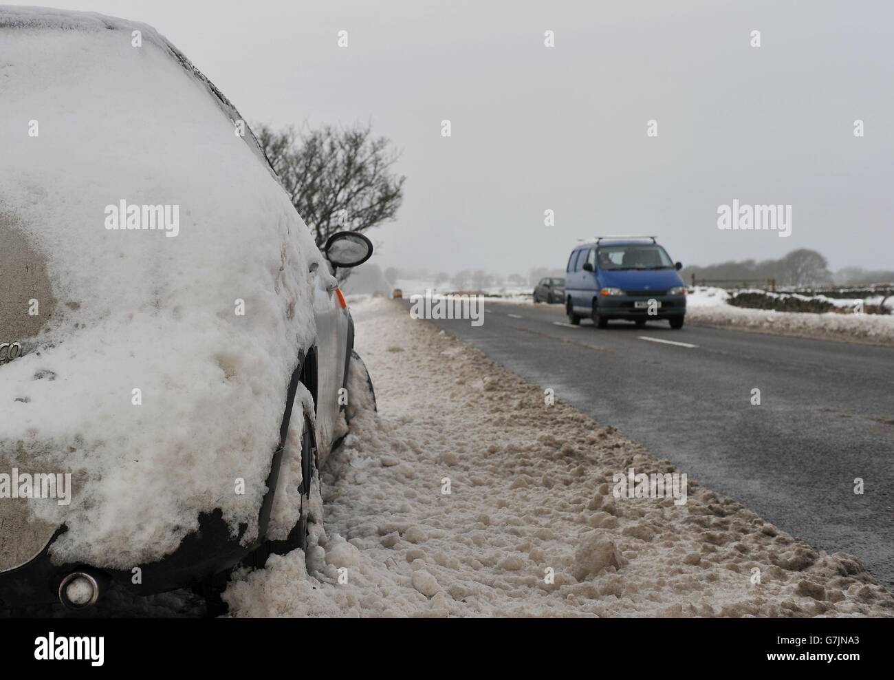 An abandoned car on the side of the A515 between Ashbourne and Buxton in Derbyshire following the coldest night of 2014 . Stock Photo