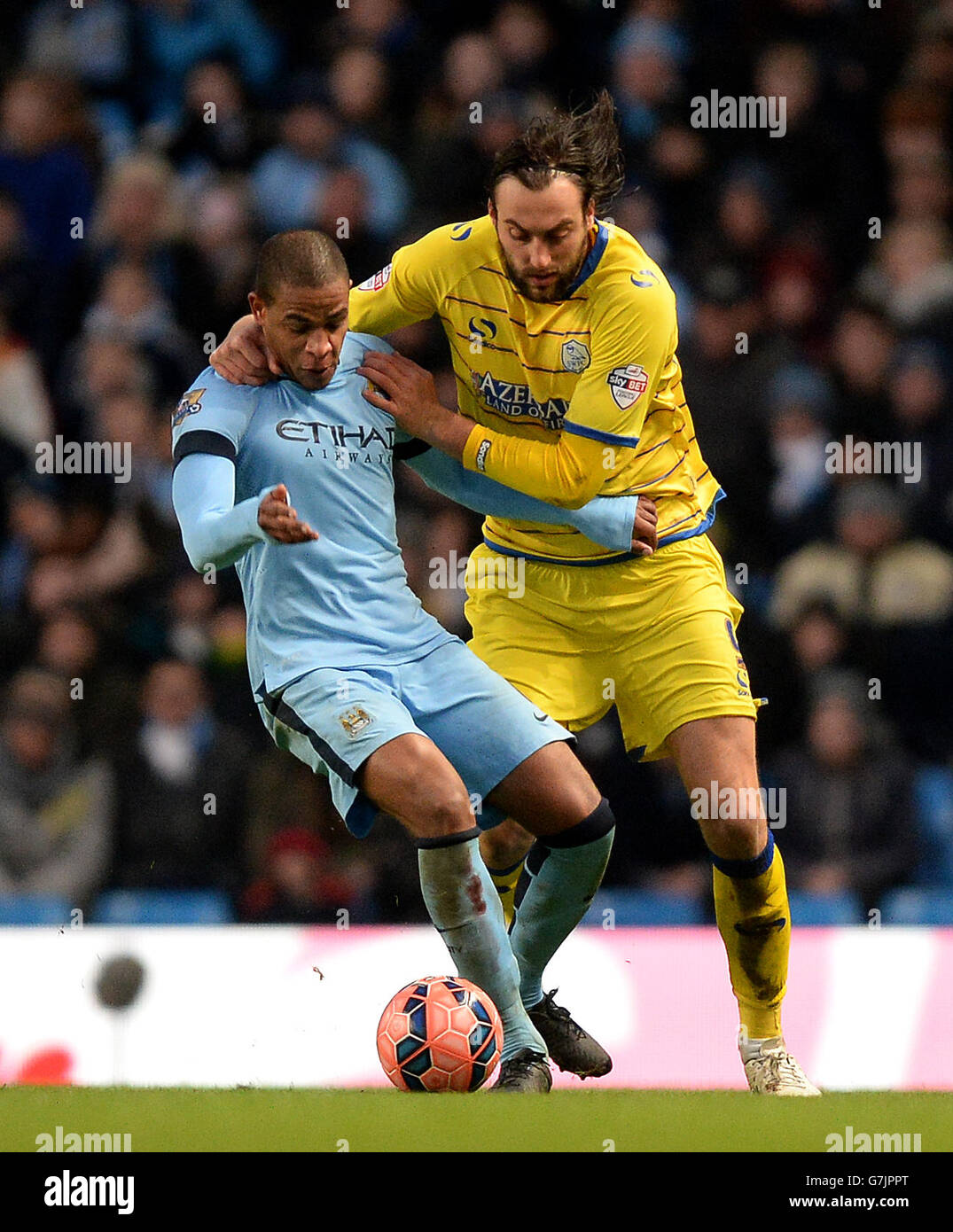 Sheffield Wednesdays Atdhe Nuhiu battles for the ball with Manchester Citys Fernando, during the FA Cup, Third Round match at the Etihad Stadium, Manchester Stock Photo