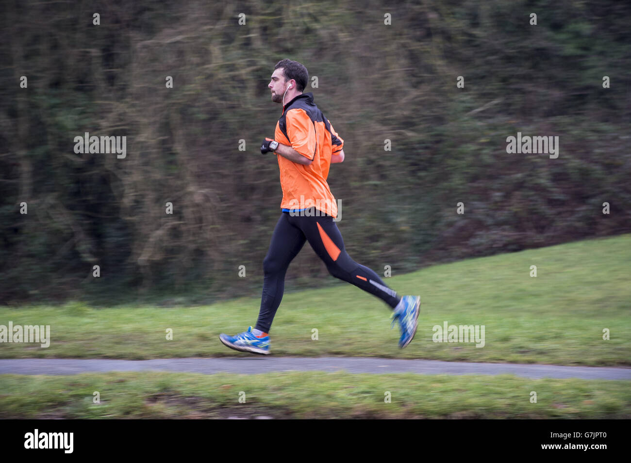 A jogger runs around Clifton Downs, Bristol in the New Year, a traditional time of year for exercise. Stock Photo